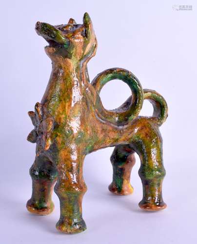 AN UNUSUAL TURKISH CANAKKALE POTTERY FIGURE OF A STYLISED LION modelled standing upon all fours.