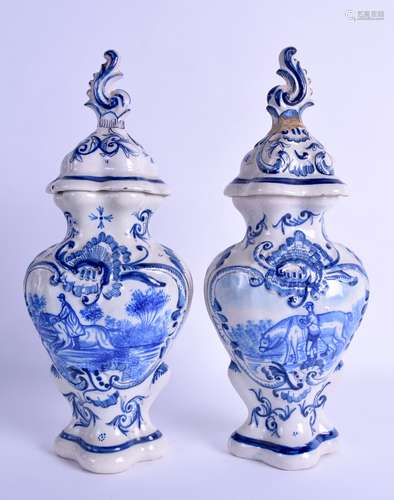 A PAIR OF 19TH CENTURY DELFT FAIENCE TIN GLAZED VASES AND COVERS painted with figures on horseback