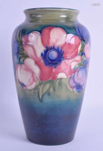 AN ANTIQUE WILLIAM MOORCROFT VASE painted with floral sprays. 21.5 cm high.