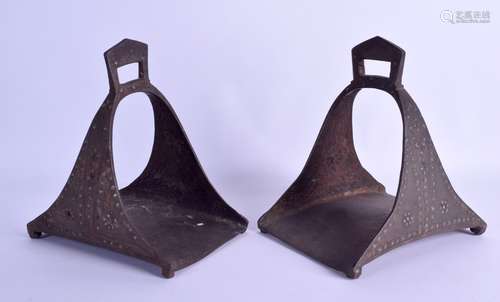 A PAIR OF 19TH CENTURY TURKISH OTTOMAN CAST IRON STIRRUPS inset with turquoise, supported upon