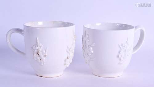 Bow coffee cup in white with applied prunus decoration and another similar.