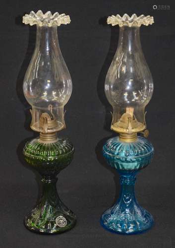 PAIR OF COLURED GLASS FISH & SHELL PATTERN OIL LAMPS. 43 cm high.