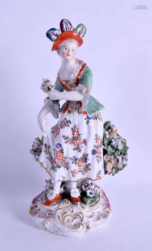 18th c. Derby figure of a woman with a feathered hat holding her dress. 19 cm high.