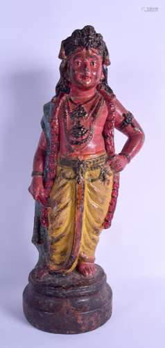 AN 18TH/19TH CENTURY INDIAN POLYCHROMED TERRACOTTA FIGURE OF A STANDING FEMALE modelled upon a