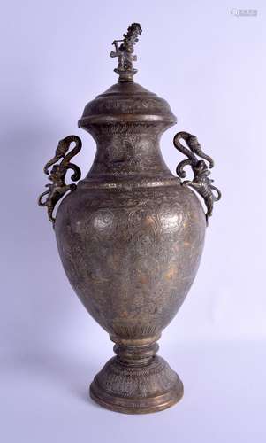 A 19TH CENTURY INDIAN TWIN HANDLED BRASS VASE AND COVER incised with figures, birds and flowers