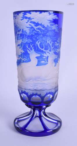 A 19TH CENTURY BOHEMIAN BLUE GLASS GOBLET finely decorated with stags roaming within landscapes.