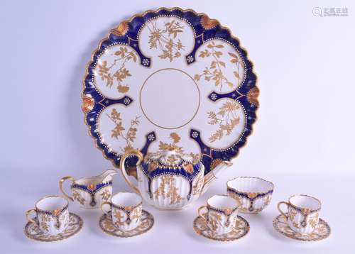 A COPELAND SPODE TETE A TETE PORCELAIN TEASET painted in gilt with flowers and vines. Tray 36 cm