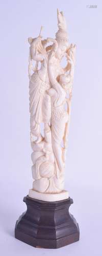 A LATE 19TH CENTURY INDIAN CARVED IVORY FIGURE modelled as a male and female upon a naturalistic