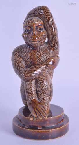 A 19TH CENTURY CONTINENTAL STONEWARE FIGURE OF A MONKEY modelled scratching his arm and back. 14