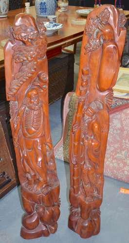 A LARGE PAIR OF 20TH CENTURY CARVED WOODEN FIGURES, formed as two immortals. 115 cm high.