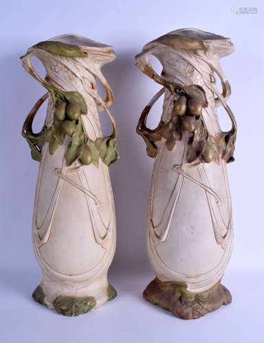 A VERY LARGE PAIR OF ART NOUVEAU ROYAL DUX TWIN HANDLED VASES overlaid with grape type vines. 48