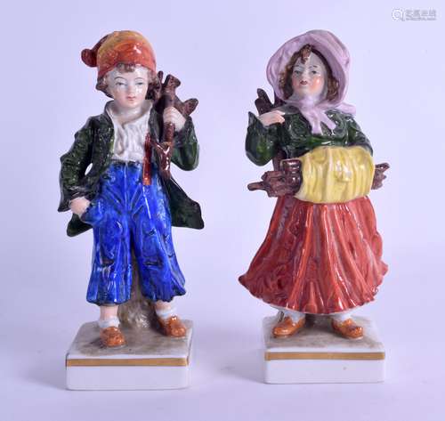 A PAIR OF LATE 19TH CENTURY GERMAN PORCELAIN FIGURES modelled as a boy and girl carrying logs. 15 cm