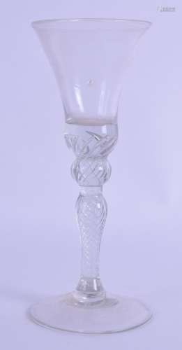 AN 18TH CENTURY GLASS with spirally twisted stem. 18.5 cm high.