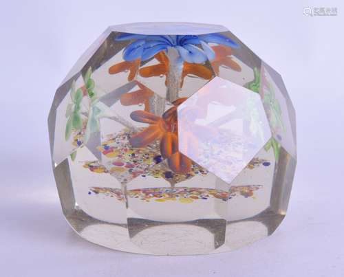 A LARGE ANTIQUE GLASS PAPERWEIGHT with upright blue flower and facetted body. 8 cm x 9.5 cm.