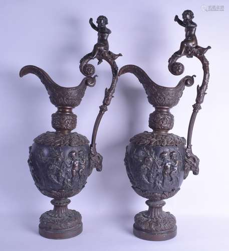 A VERY LARGE PAIR OF 19TH CENTURY FRENCH BRONZE EWERS with figural handles, smothered in birds, mask