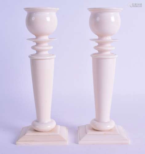 A GOOD PAIR OF 19TH CENTURY EUROPEAN CARVED IVORY CANDLESTICKS of classical form upon rectangular