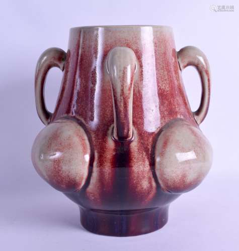 A STYLISH CONTINENTAL FLAMBE GLAZED FOUR HANDLED VASE decorated in relief with large raised