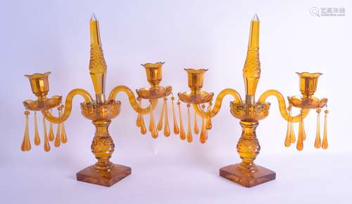 A STYLISH PAIR OF ANTIQUE BOHEMIAN SMOKEY AMBER GLASS CANDLEABRA with facetted stems, upon square