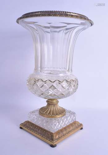 A FINE REGENCY CUT GLASS AND ORMOLU VASE with facetted body and acanthus capped mounts. 35 cm x 21