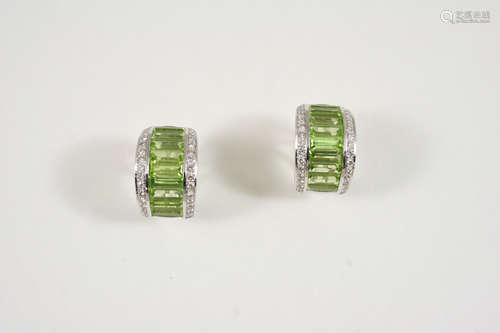 A PAIR OF PERIDOT AND DIAMOND EARRINGS each earring is centred with a row of baguette-shaped