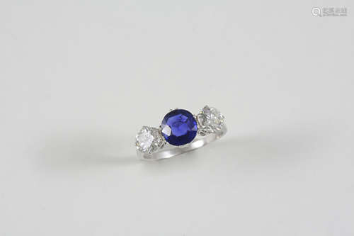 A SAPPHIRE AND DIAMOND THREE STONE RING the cushion-cut sapphire is set with two brilliant-cut