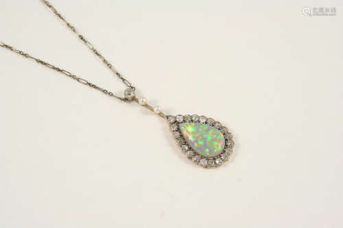 AN OPAL AND DIAMOND CLUSTER PENDANT the pear-shaped solid white opal is set within a surround of old