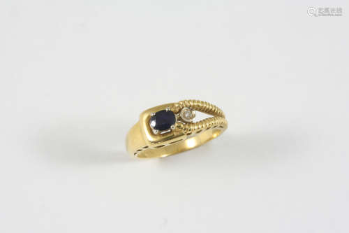 A SAPPHIRE AND DIAMOND RING the 18ct.gold ring is set with an oval-shaped sapphire and a circular-