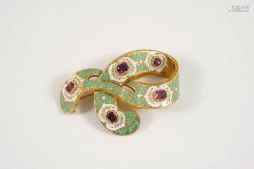 A 19TH CENTURY CONTINENTAL ENAMEL BROOCH the swirling design is decorated with green and white