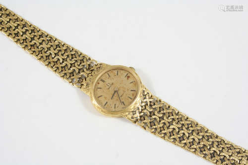 A LADY'S 18CT. GOLD WRISTWATCH BY OMEGA the signed oval-shaped dial with baton numeals, on an