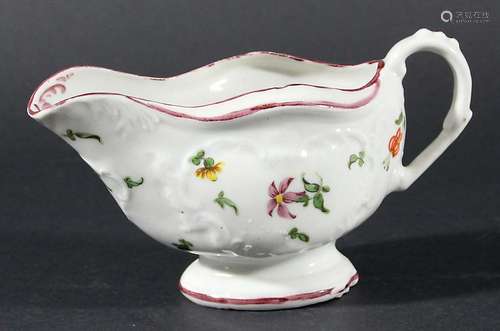 BRISTOL PORCELAIN SAUCEBOAT, circa 1770, probably Champions, painted with floral sprigs on a moulded