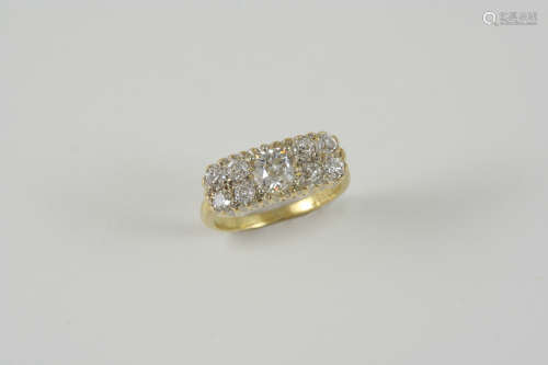A DIAMOND PLAQUE RING centred with an old brilliant-cut diamond with four smaller old brilliant-