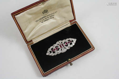 AN ART DECO RUBY AND DIAMOND DOUBLE CLIP BROOCH centred with calibre-cut rubies within an openwork