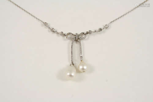 AN EDWARDIAN DIAMOND AND NATURAL PEARL NECKLACE the foliate and bow design is set with small rose-