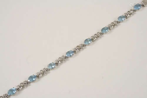 AN AQUAMARINE AND DIAMOND BRACELET set alternately with oval-shaped aquamarines and a diamond set