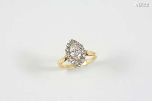 A DIAMOND CLUSTER RING the marquise-shaped diamond is set within a surround of twelve old