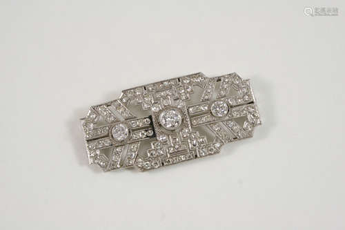 AN ART DECO DIAMOND PANEL BROOCH the openwork design is centred with three graduated old brilliant-