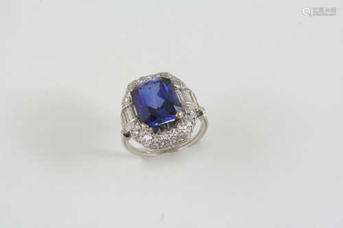 A SYNTHETIC SAPPHIRE AND DIAMOND CLUSTER RING the rounded rectangular-shaped synthetic sapphire is