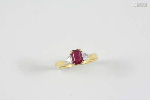 A RUBY AND DIAMOND THREE STONE RING the octagonal-shaped ruby is set with two triangular-shaped