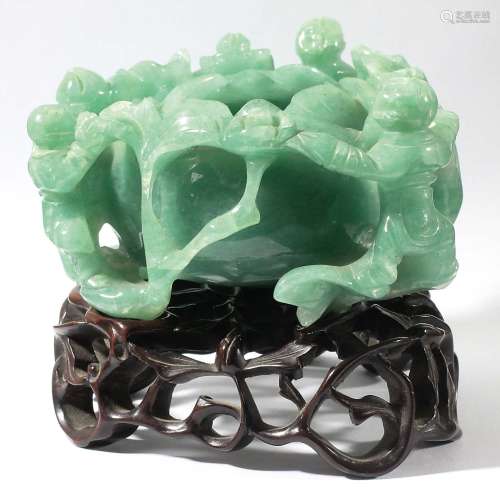 CHINESE JADE TYPE LOTUS BOWL, carved with three figures around the outside, on a pierced hardwood