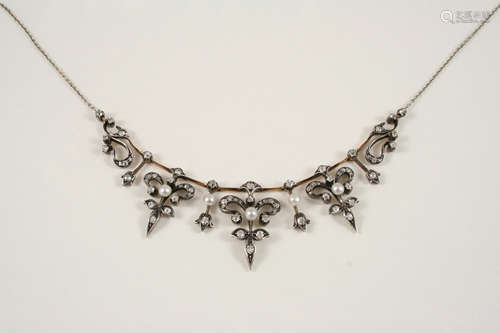 A VICTORIAN DIAMOND AND PEARL SET NECKLACE formed with graduated foliate drops,suspended from a