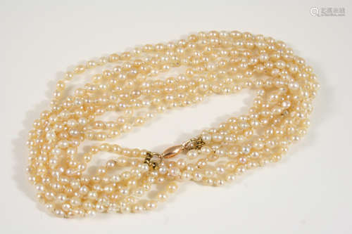 A FOUR ROW SLIGHTLY GRADUATED NATURAL PEARL NECKLACE the pearls are set to gold barrel clasp,