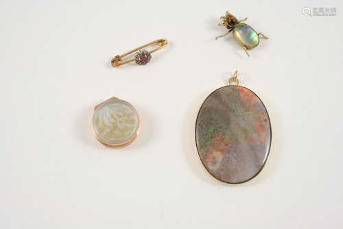 AN OPAL AND GOLD PENDANT the oval-shaped opal is set within a 9ct. gold mount, 4cm. long, together