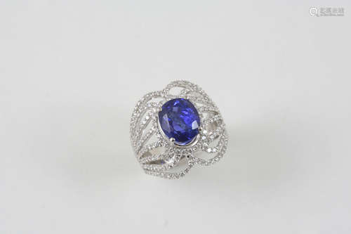 A SAPPHIRE AND DIAMOND RING the oval-shaped sapphire weighs 5.63 carats and is set within an