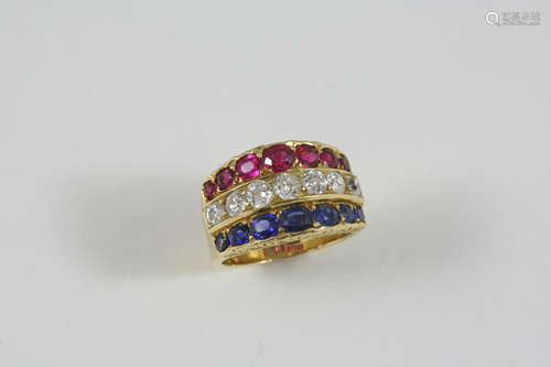 A DIAMOND, RUBY AND SAPPHIRE TRIPLE ROW RING the 18ct. gold ring is centred with a row of