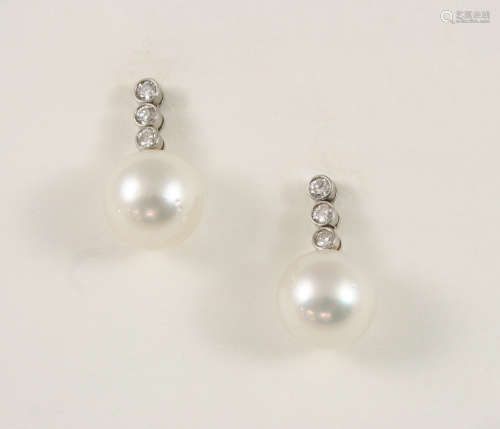 A PAIR OF CULTURED PEARL AND DIAMOND DROP EARRINGS each earring set with a cultured pearl