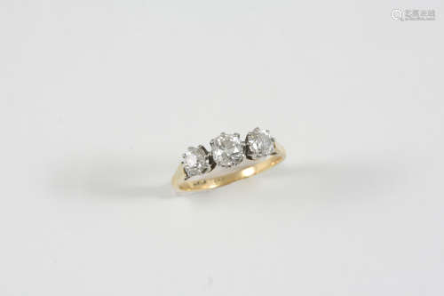 A DIAMOND THREE STONE RING the three graduated cushion-shaped diamonds are set in 18ct. gold and