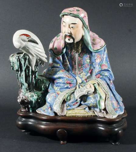 CHINESE ENAMELLED GROUP, of a sage seated with a stork, a book on his lap, in Canton style