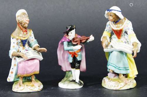 TWO MEISSEN STYLE MONKEY BAND FIGURES, each as a 'lady' holding a music book, blue Vienna style