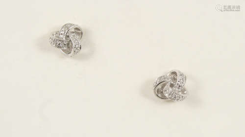 A PAIR OF DIAMOND KNOT EARRINGS each earring set with circular-cut diamonds, in 18ct. white gold.