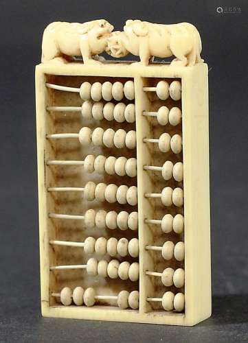 CHINESE IVORY CANTON ABACUS, 19th century, carved with a figural scene surmounted by a pair of